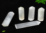 Selenite obelisk tower crystal by GemstoneGO, showcasing a smooth, white mineral structure with natural striations and polished surface.