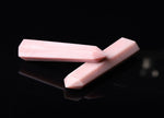 Pink Opal obelisk tower crystal from GemstoneGO showing a smooth, polished pink gemstone with natural striations and a pointed top.