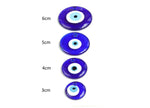 Blue glass evil eye pendant with hole for jewelry or home decor, featuring a protective evil eye design by GemstoneGO.