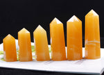 Yellow aventurine obelisk tower crystal from GemstoneGO, showcasing a polished yellow gemstone with a pointed obelisk shape.