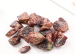 Raw garnet gemstone from GemstoneGO, showcasing its deep red, uncut mineral with natural crystalline structure.