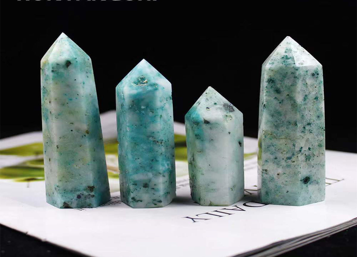 GemstoneGO Phoenix Obelisk Tower Crystal with clear, polished facets and a tall, elegant shape on a white background.