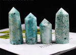 GemstoneGO Phoenix Obelisk Tower Crystal with clear, polished facets and a tall, elegant shape on a white background.