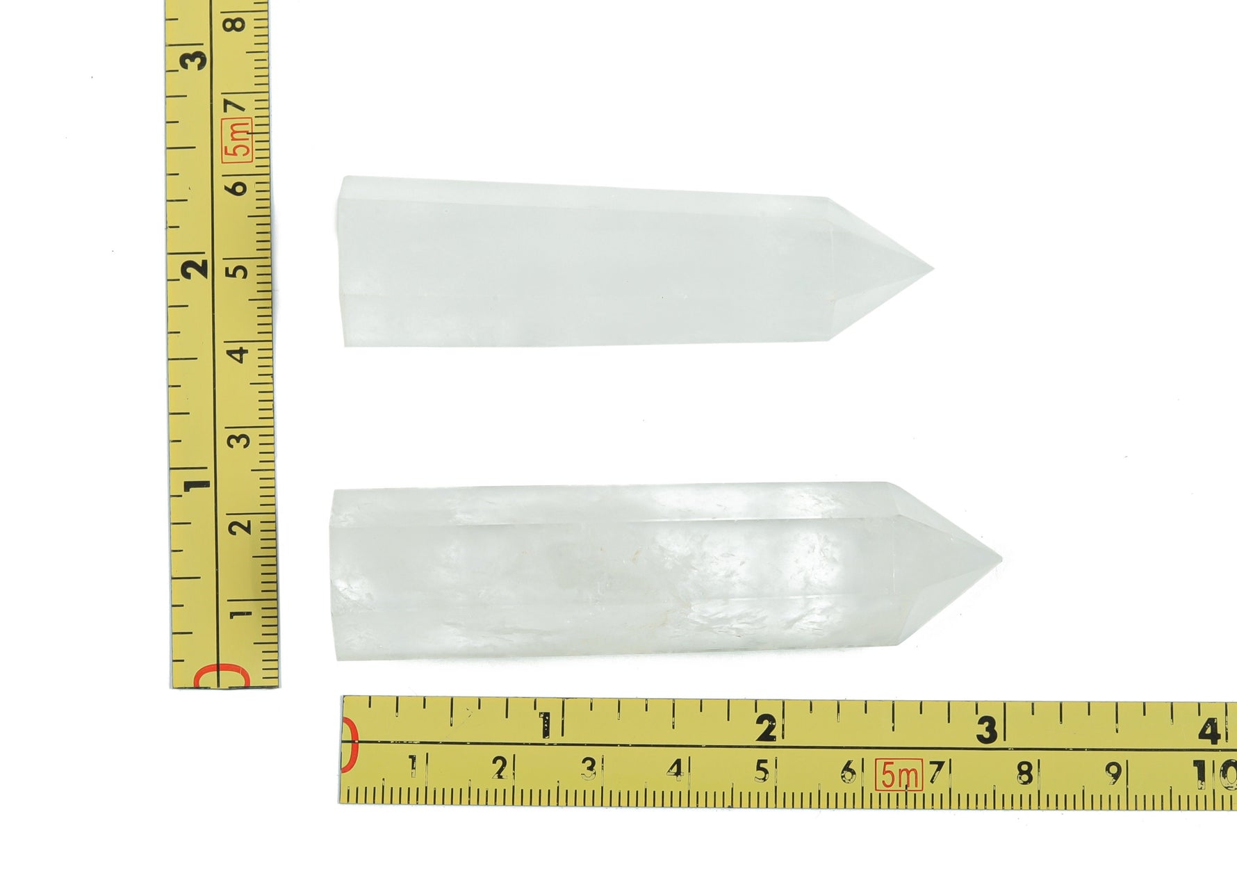 Clear Quartz obelisk tower crystal from GemstoneGO, showcasing a tall, transparent gemstone with natural crystal formations.