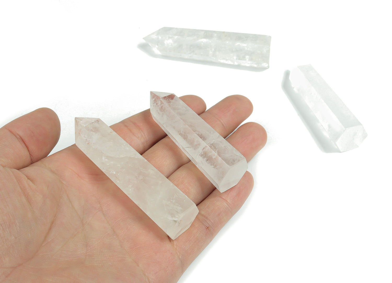 Clear Quartz obelisk tower crystal from GemstoneGO, showcasing a transparent, polished quartz with natural striations and a pointed top.
