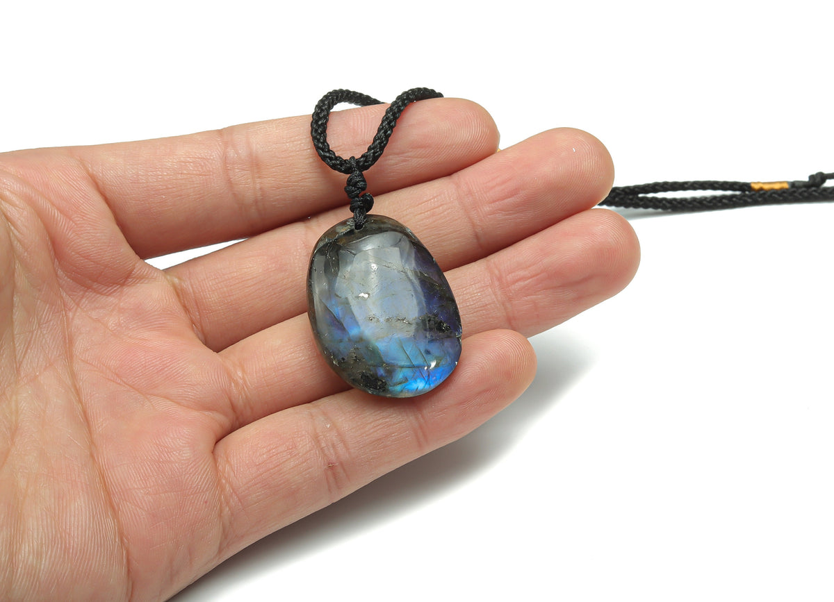 Labradorite crystal necklace on a cord with gemstone details, showcasing the polished stone and handcrafted design.