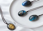 Labradorite crystal necklace on a cord, featuring a polished gemstone pendant, ideal for gifts or everyday wear.
