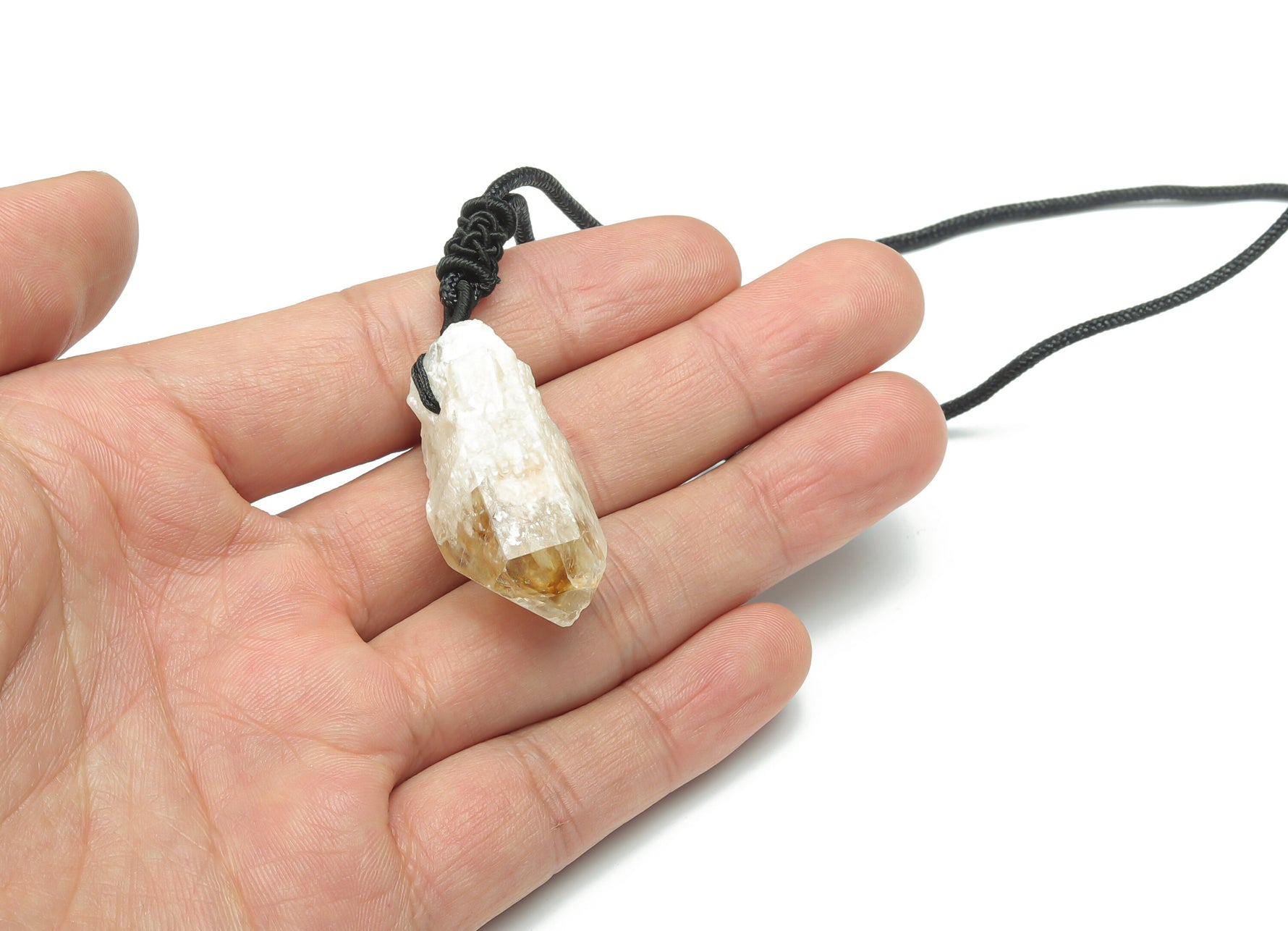 Citrine crystal pendant on a cord necklace from GemstoneGO, showcasing a polished yellow gemstone with a simple black cord.