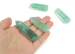 Green fluorite obelisk tower crystal from GemstoneGO, showcasing its vibrant green color and polished geometric shape.