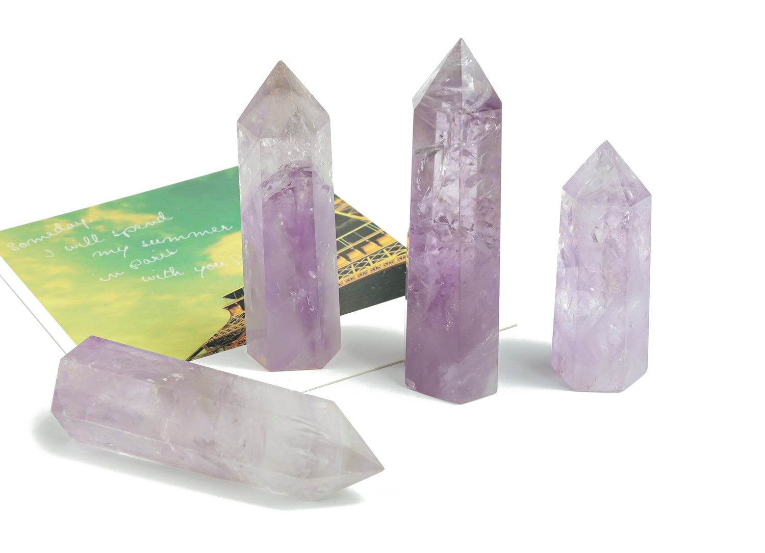 Amethyst obelisk tower crystal from GemstoneGO, showcasing purple gemstone with natural crystal formations and polished sides.