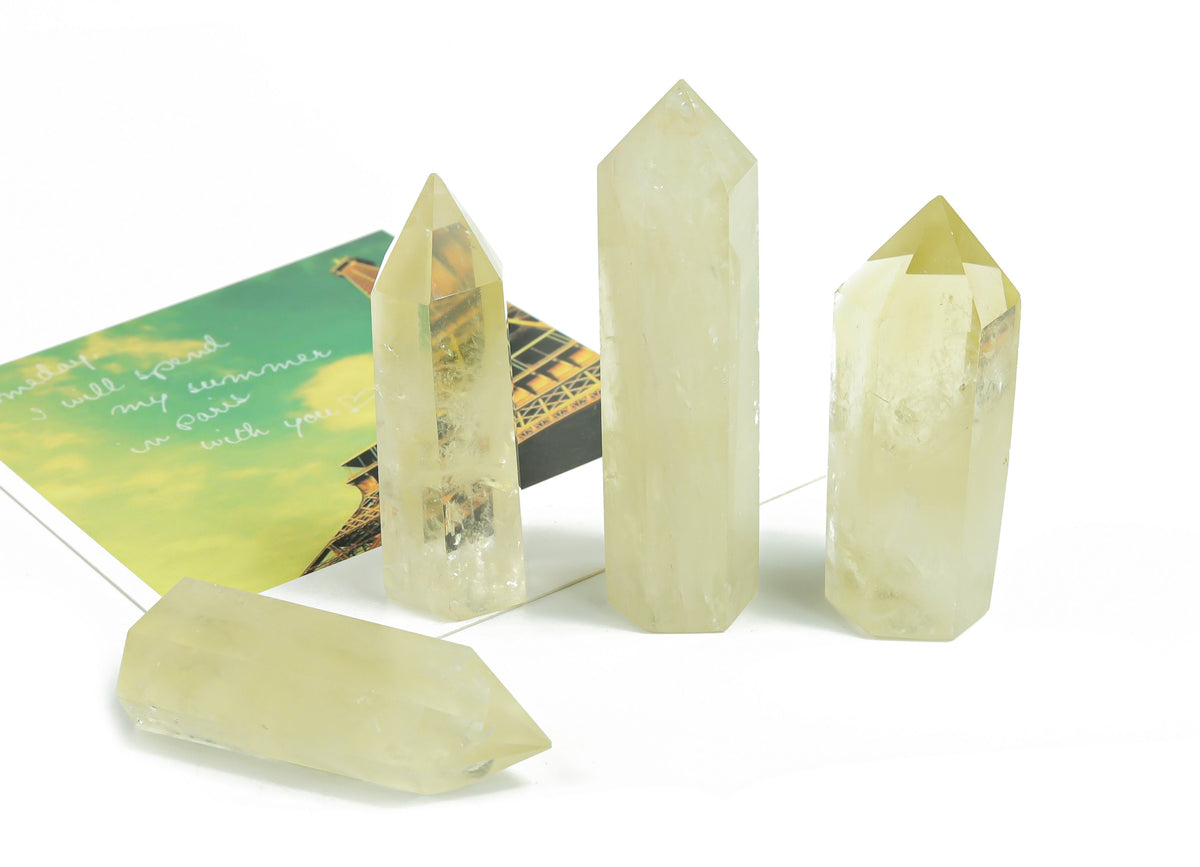 Citrine obelisk tower crystal from GemstoneGO, showcasing a vibrant yellow-orange gemstone with a pointed top and polished surface.
