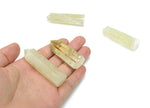 Citrine obelisk tower crystal from GemstoneGO, showcasing a bright yellow gemstone with natural crystal formations on a neutral background.