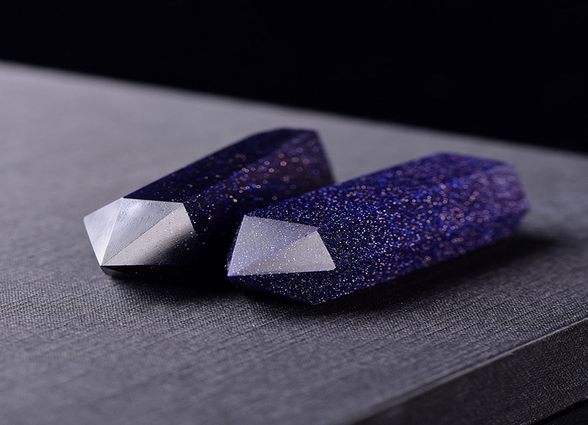 Blue Goldstone obelisk tower crystal from GemstoneGO with a polished, deep blue and gold flecked surface, standing upright.