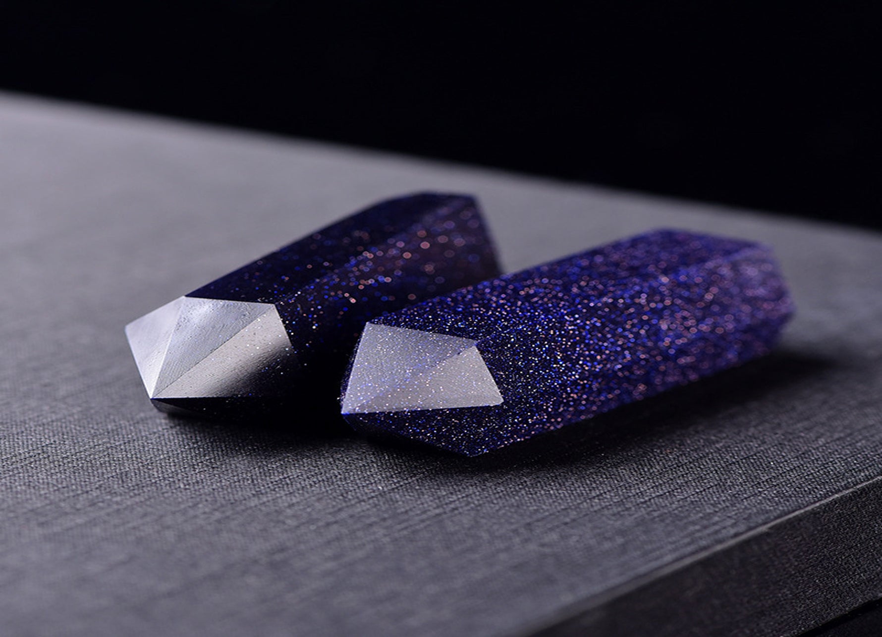 Blue Goldstone obelisk tower crystal from GemstoneGO with a polished, deep blue and gold flecked surface, standing upright.