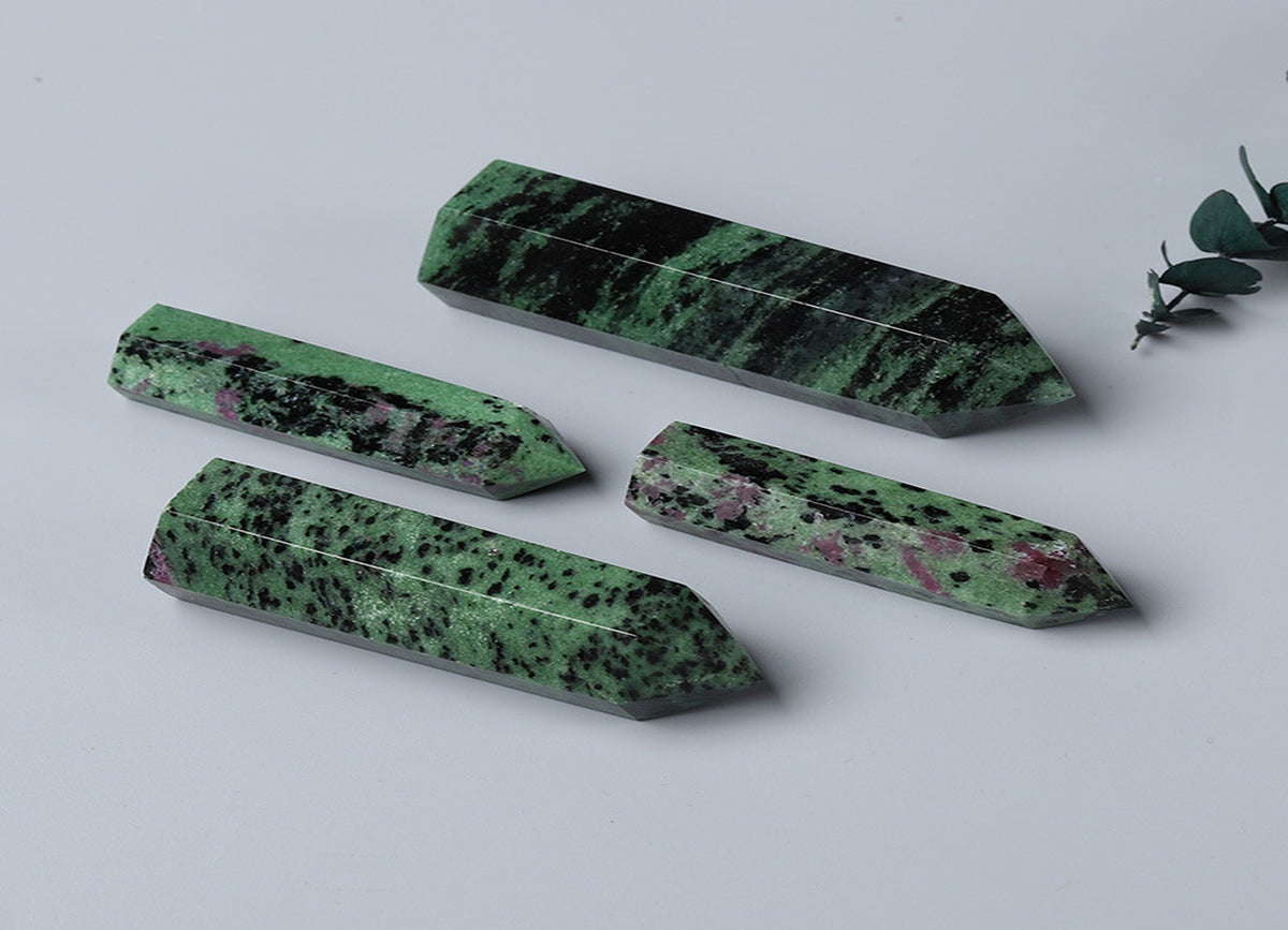 Ruby Zoisite obelisk tower crystal from GemstoneGO, showcasing a vibrant green and red gemstone with a pointed obelisk shape.
