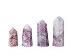 Plum Blossom Tourmaline obelisk tower crystal from GemstoneGO, showcasing vibrant pink and green gemstone colors and polished surface.