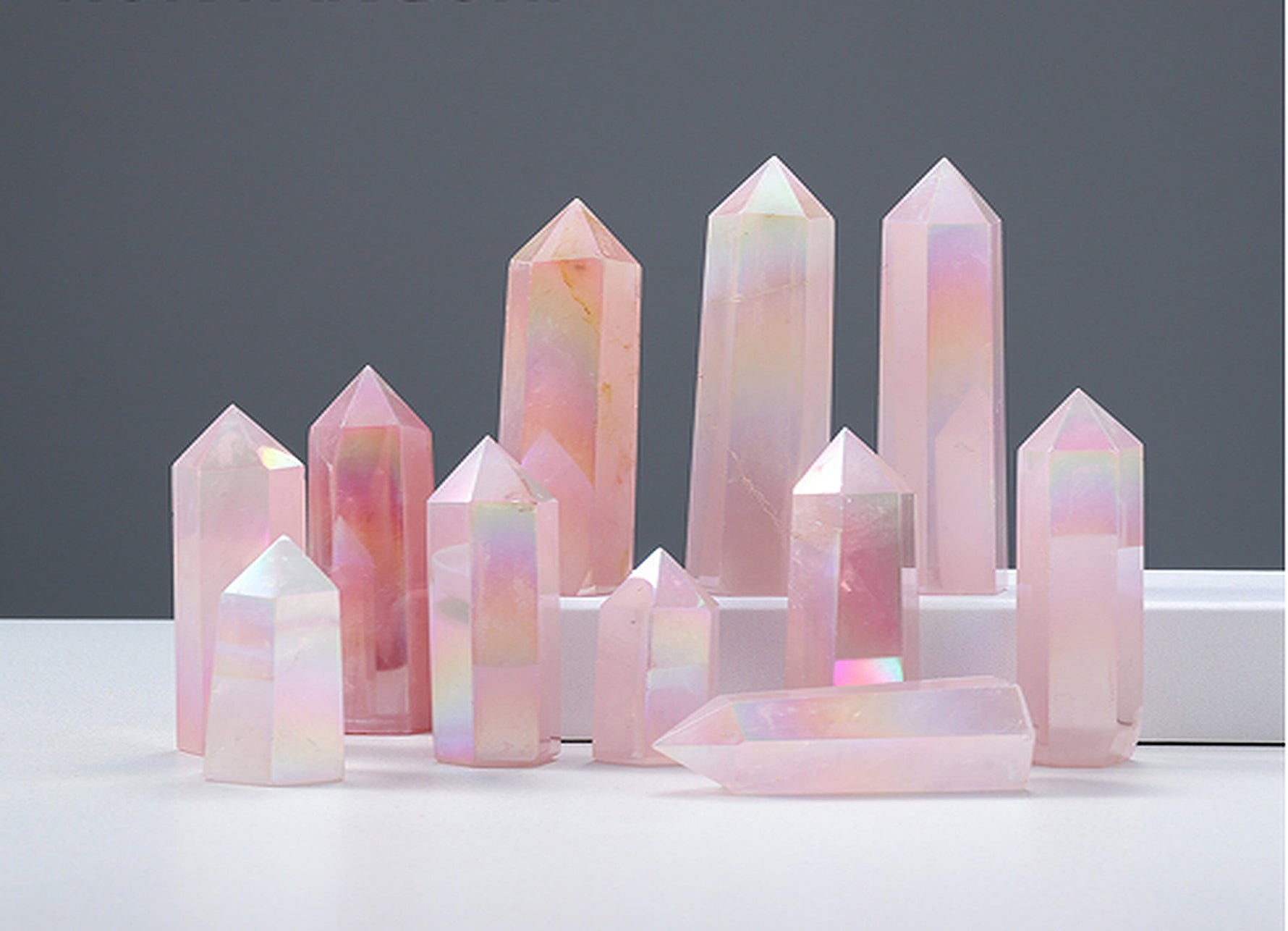 Angel Aura Rose Quartz obelisk tower crystal from GemstoneGO, featuring a luminous pink quartz gemstone with iridescent aura finish.