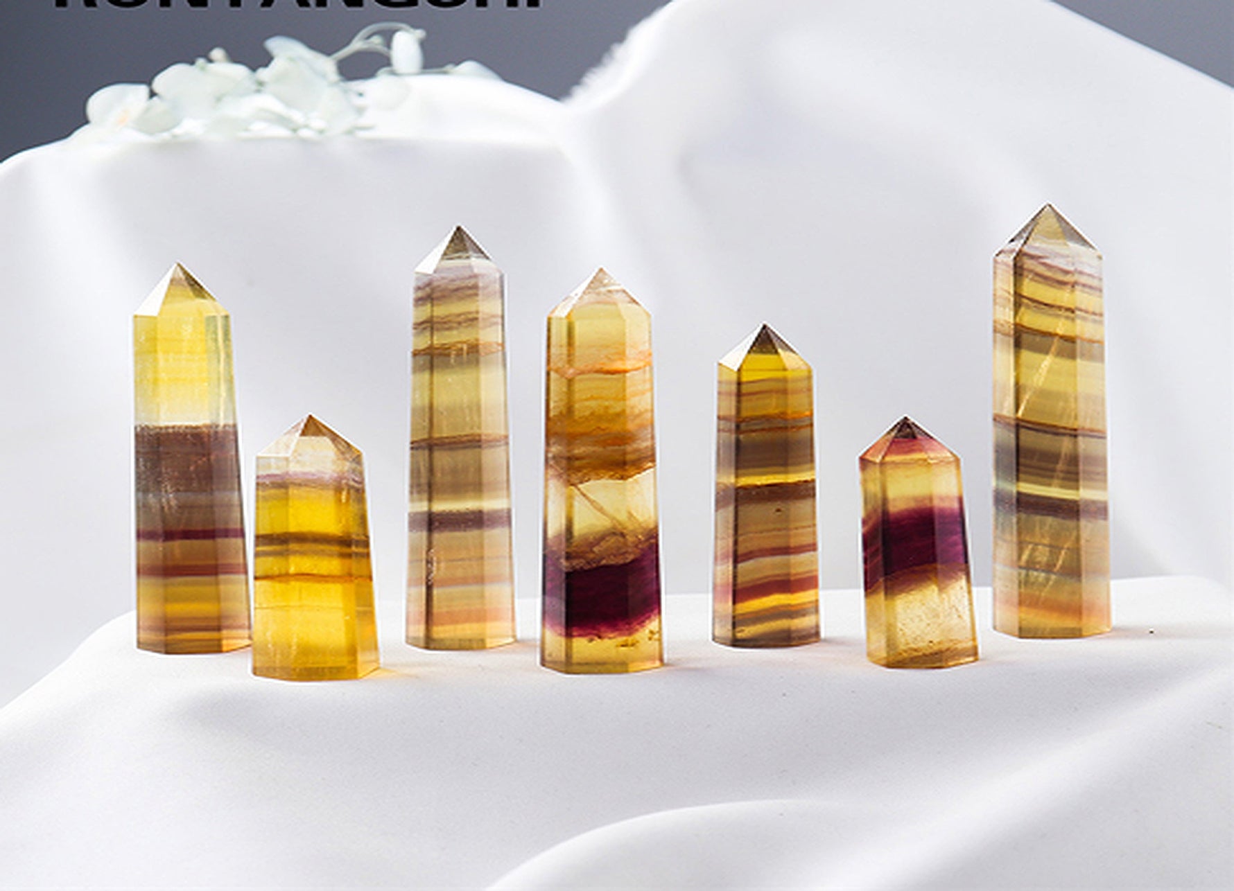 Yellow fluorite obelisk tower crystal from GemstoneGO, showcasing a smooth, vibrant yellow mineral with natural crystal formations.