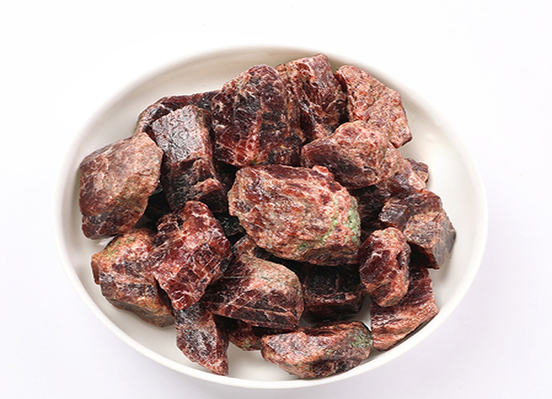 Raw garnet gemstone from GemstoneGO, showcasing its deep red color and natural, uncut mineral form.