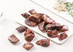 Raw garnet gemstone from GemstoneGO, showcasing its deep red color and natural irregular shape on a plain background.