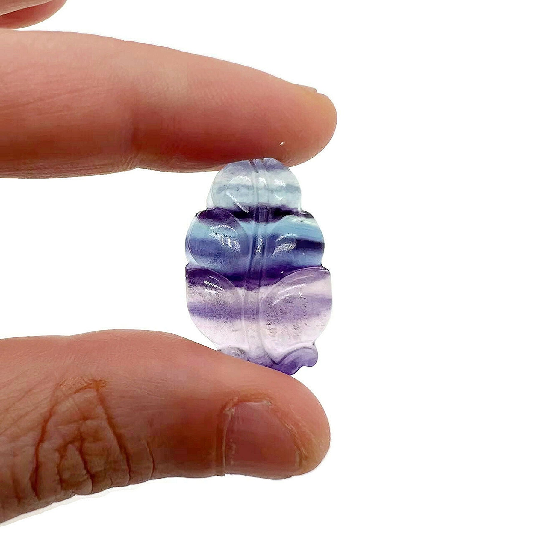 Fluorite leaf carving gemstone from GemstoneGO, showing vibrant green and purple hues with detailed leaf design and polished finish.