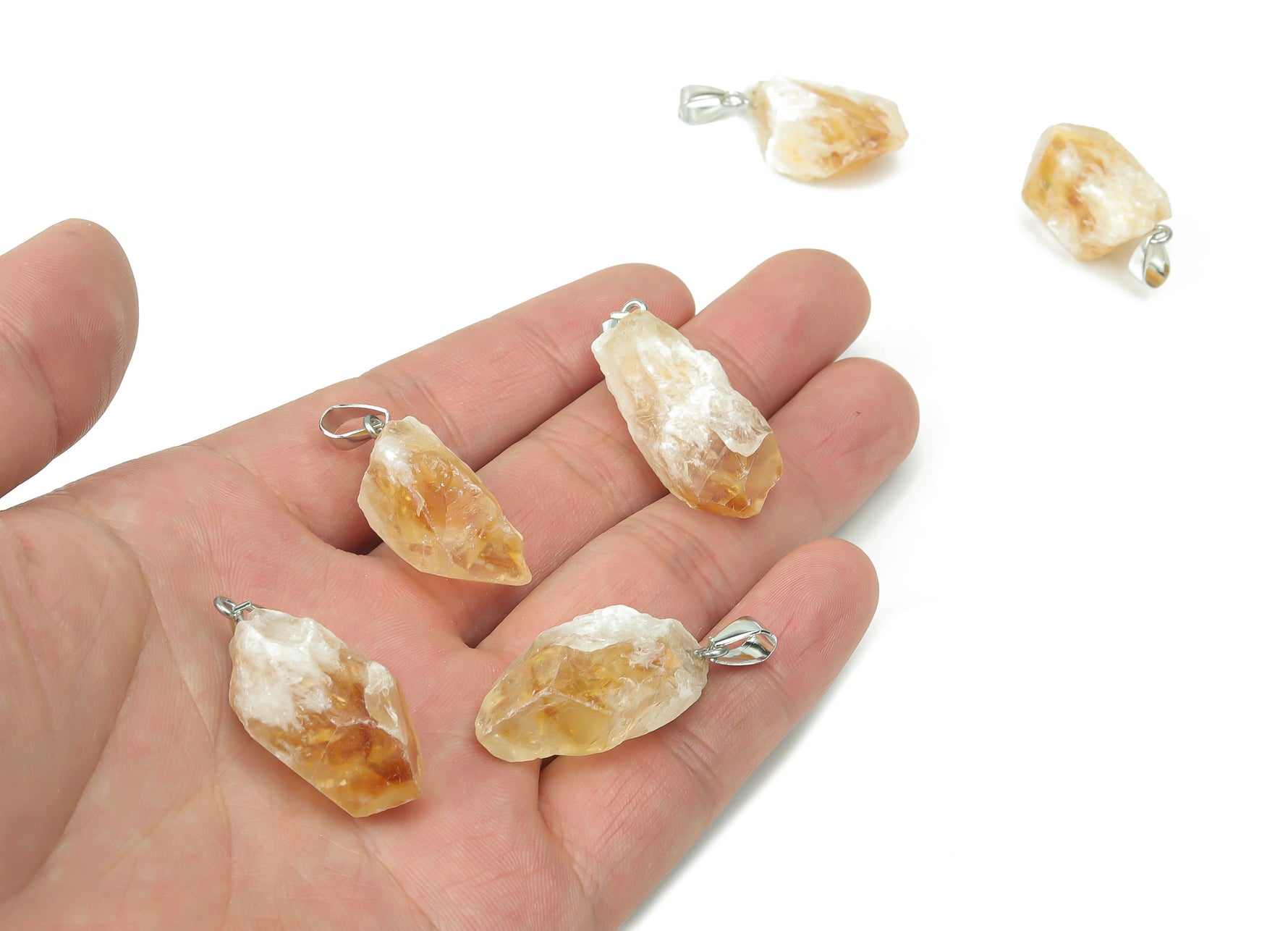 Citrine crystal pendant from GemstoneGO for jewelry making, showing a polished yellow gemstone on a silver bail.