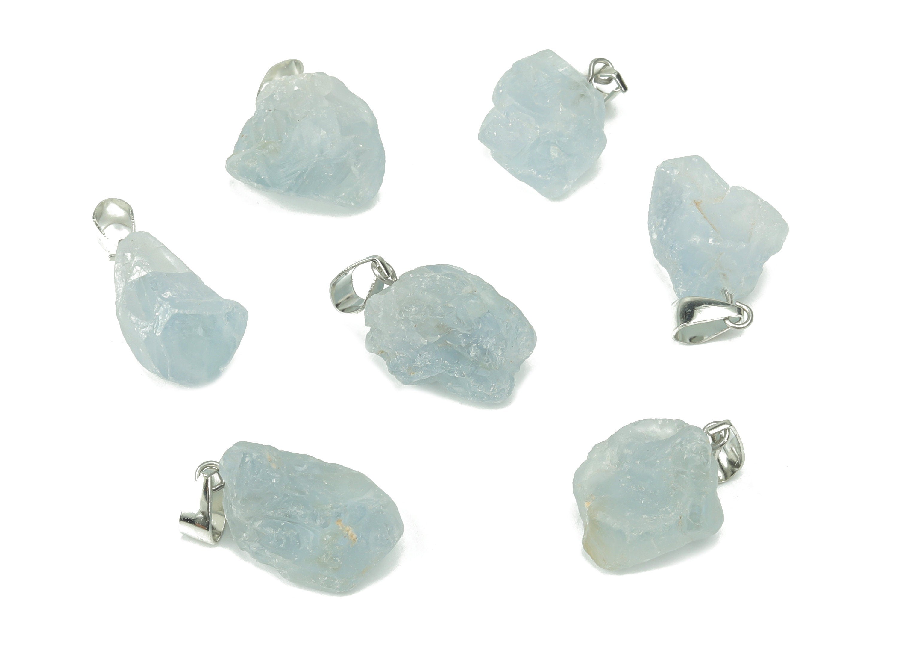 Celestite crystal pendant from GemstoneGO, showing a blue and white gemstone shaped for jewelry making on a jewelry-making supply background.