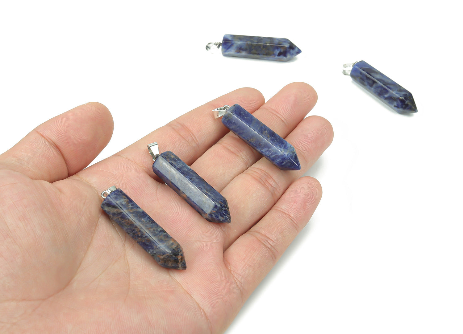 Sodalite point crystal pendant from GemstoneGO, featuring a deep blue and white veined gemstone for jewelry making supplies.