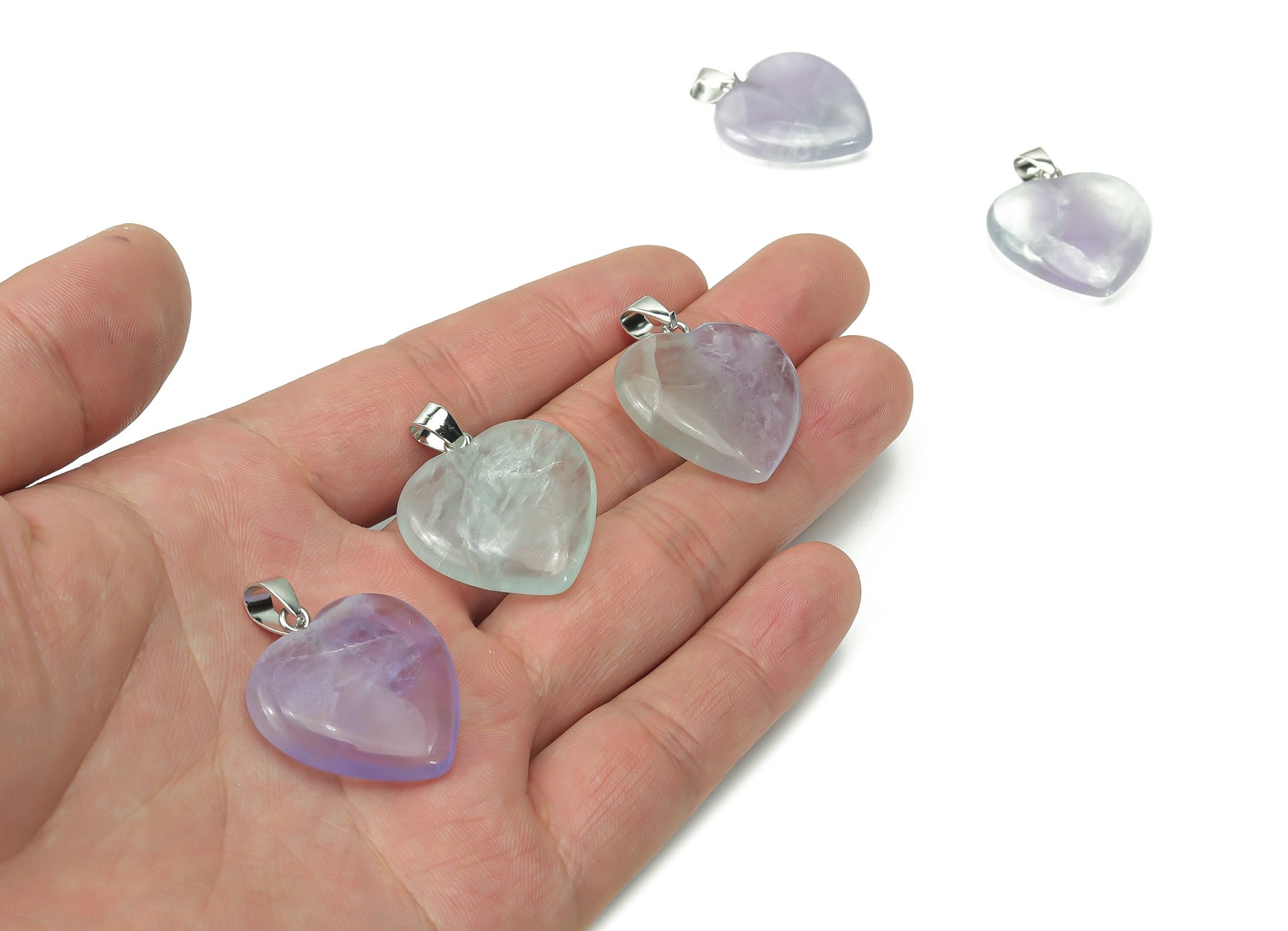 Green fluorite heart crystal pendant from GemstoneGO, ideal for jewelry making, showcasing a polished heart-shaped gemstone.