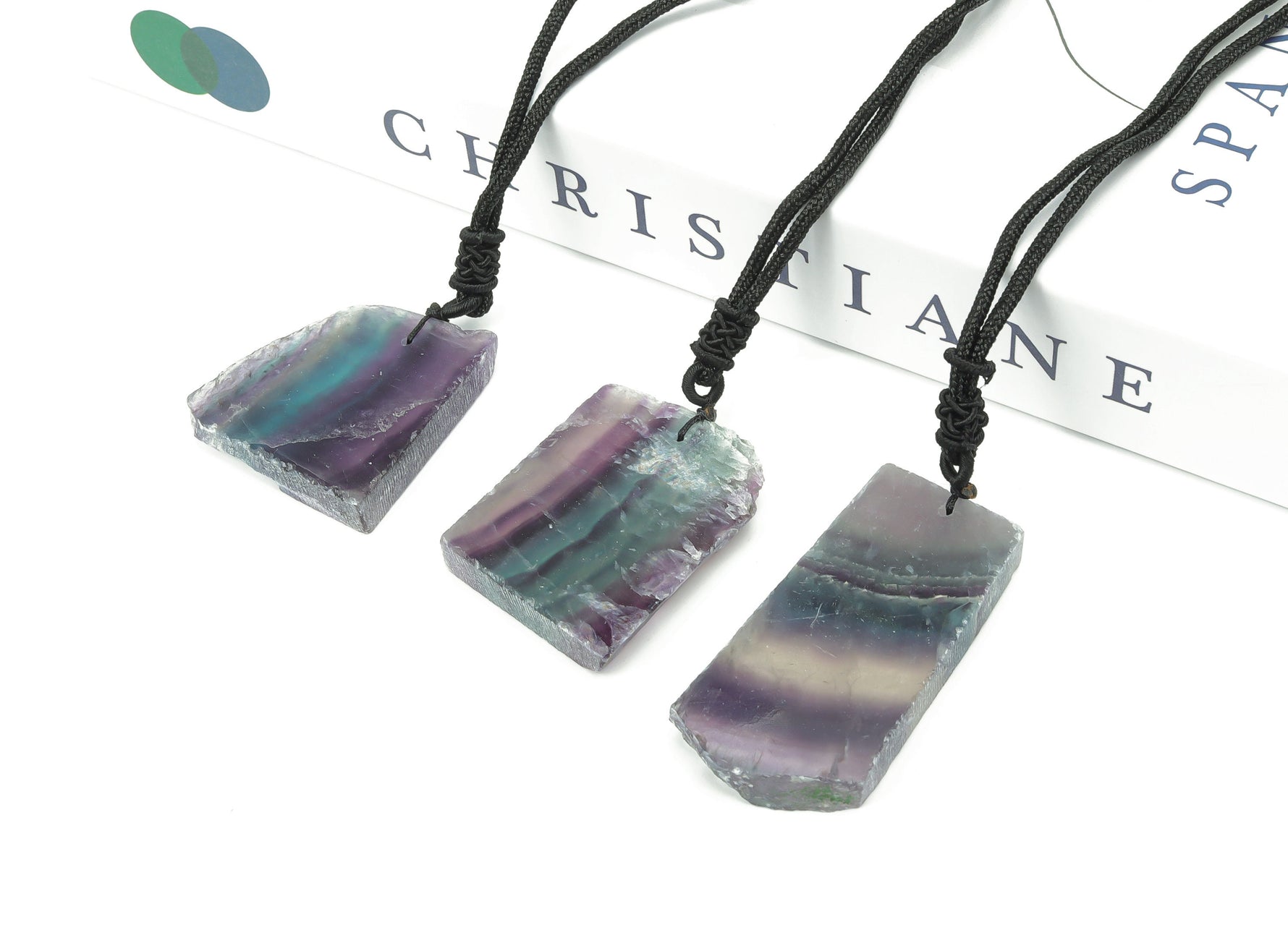 Fluorite slab crystal necklace on cord, featuring vibrant purple and green hues, by GemstoneGO.