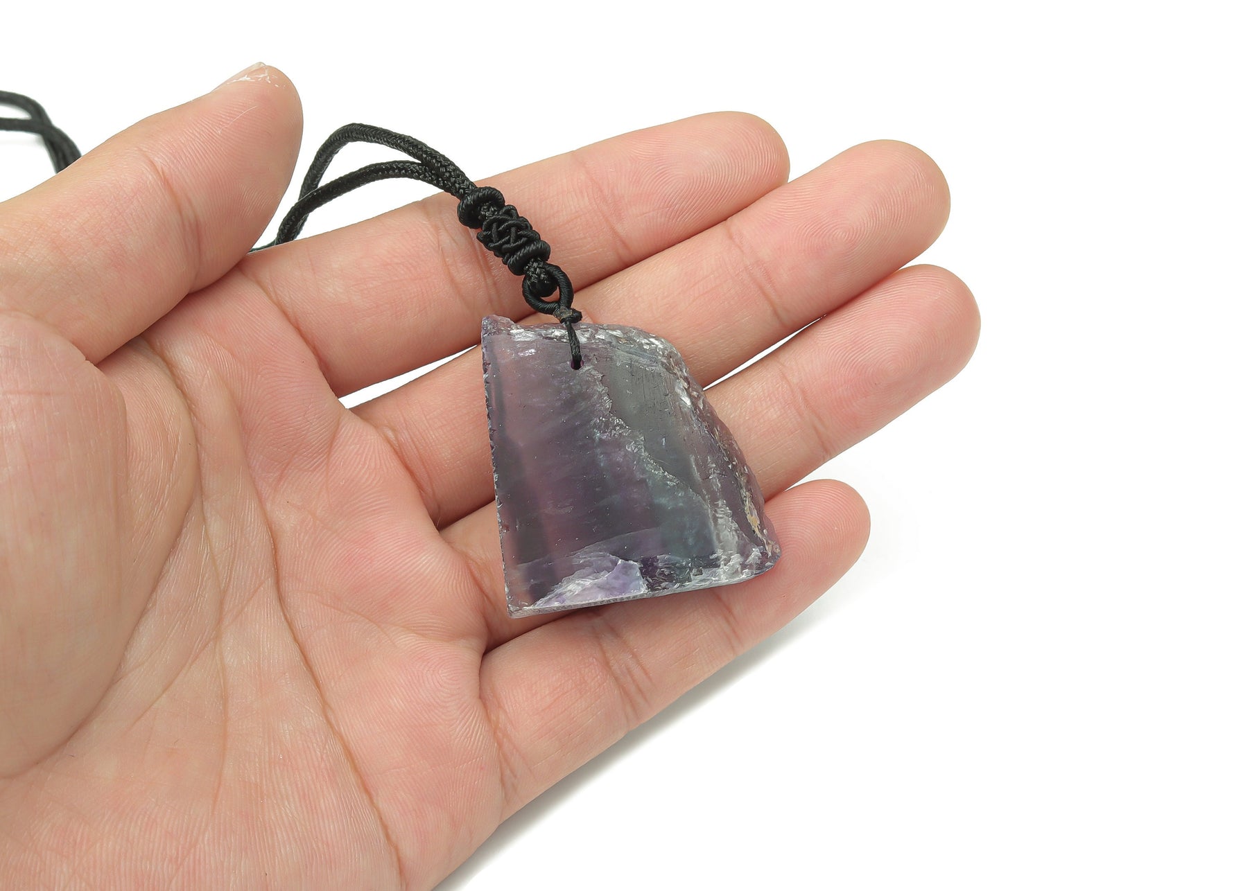 Fluorite slab crystal necklace on a cord from GemstoneGO, showcasing vibrant green and purple mineral hues.