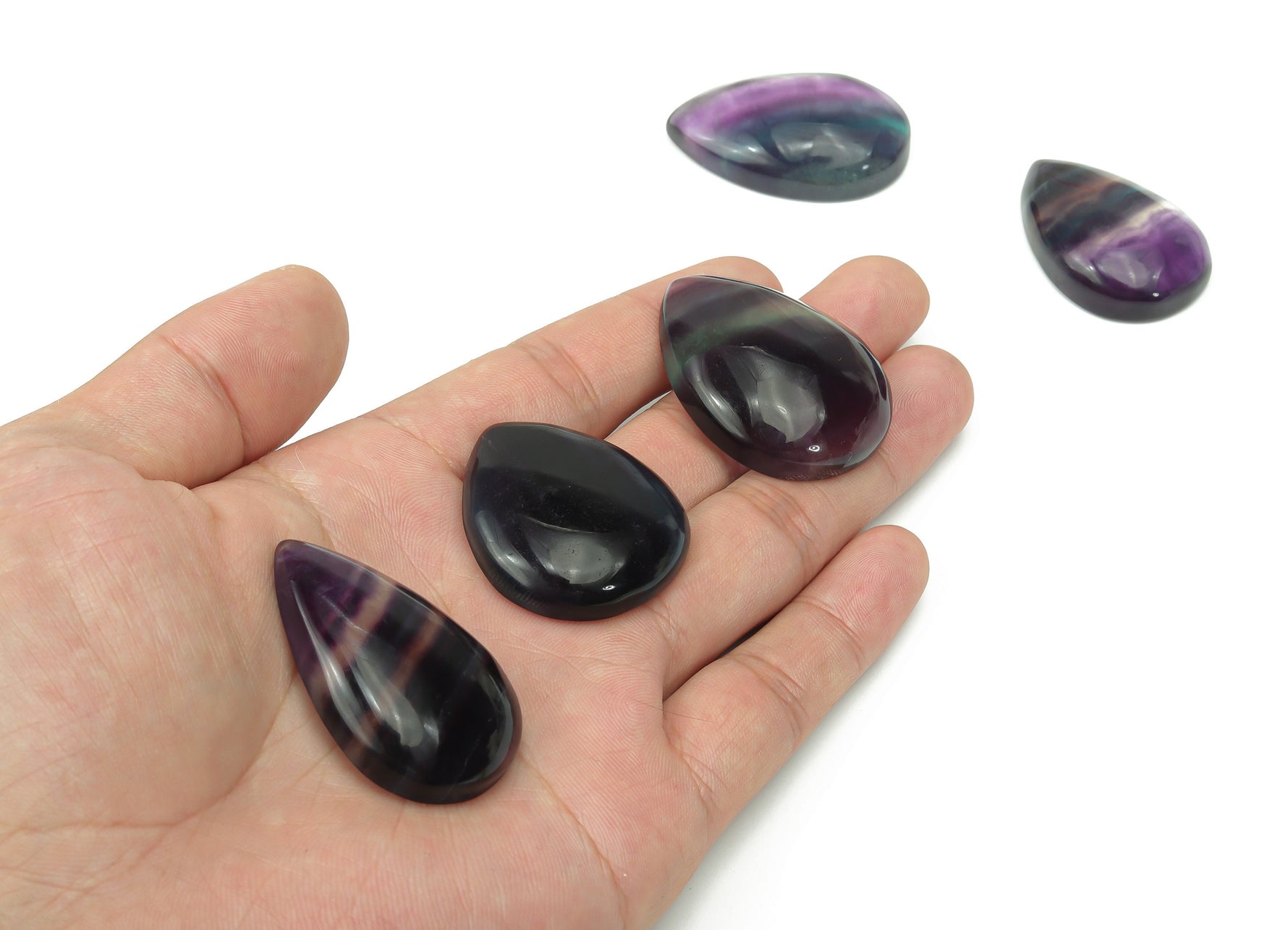 Fluorite crystal carving gemstone from GemstoneGO, showcasing vibrant purple and green hues with intricate natural patterns.