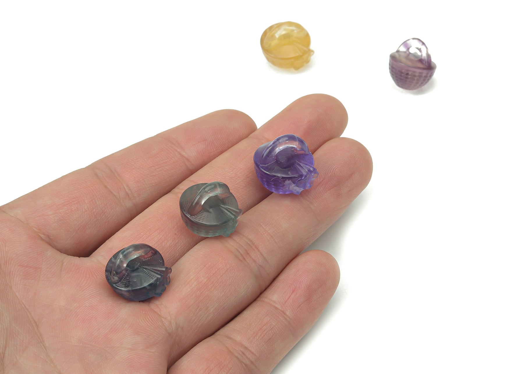 Fluorite garden basket carving gemstone by GemstoneGO, featuring intricate floral design and vibrant green and purple hues.