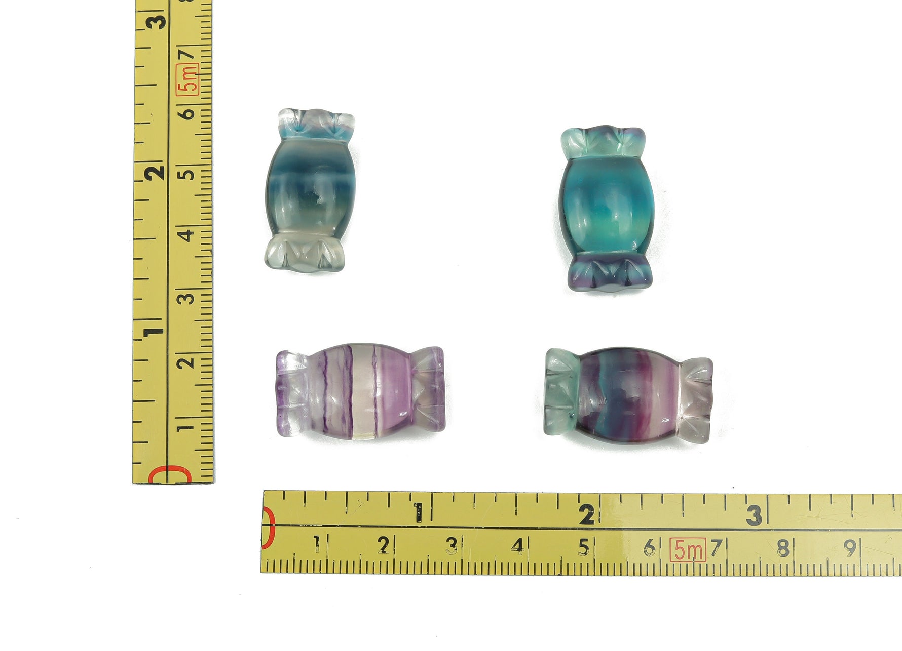 Fluorite candy carving gemstone by GemstoneGO showcasing vibrant green and purple hues with intricate carving details.