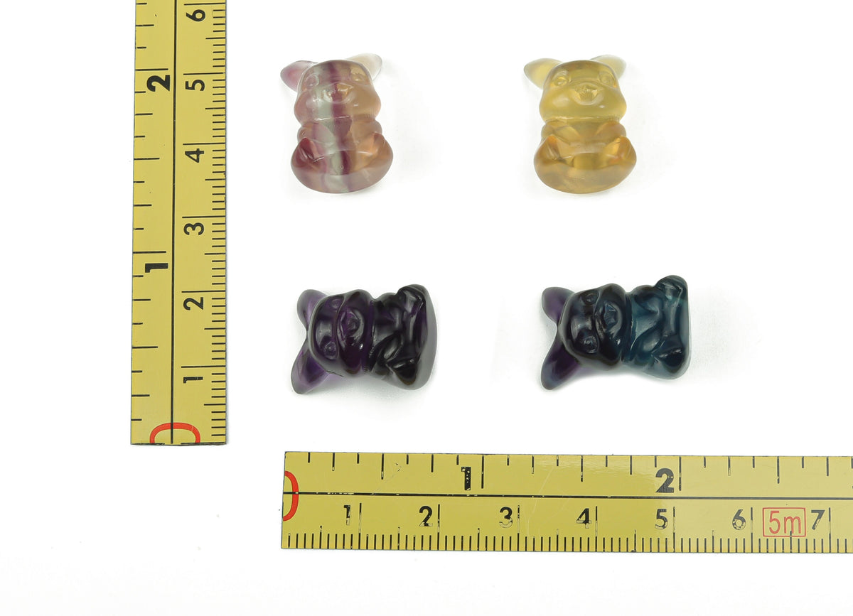 Colorful fluorite gemstone carved into a cute animal shape, showcasing vibrant hues and detailed craftsmanship.