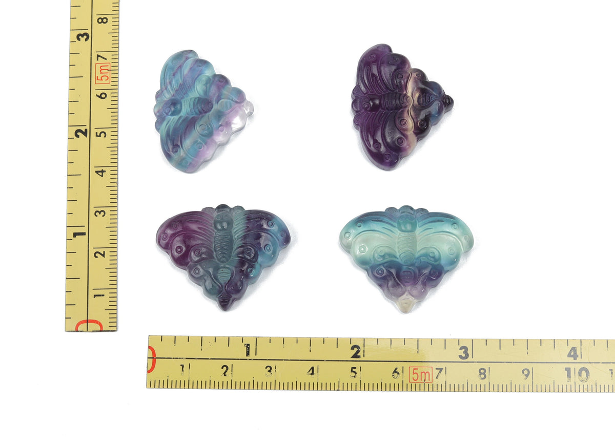 Beautiful fluorite butterfly carving gemstone from GemstoneGO, showcasing vibrant purple and green hues and intricate butterfly details.