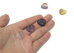 Polished fluorite heart-shaped gemstone carving from GemstoneGO, showcasing vibrant purple and green hues with smooth surface details.