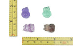 Polished fluorite owl carving gemstone from GemstoneGO, showing vibrant purple, green, and blue hues with detailed feather texture.