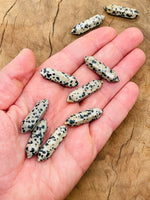 Dalmatian Jasper terminated carved point gemstone from GemstoneGO, 33mm, featuring distinctive black spots on a light stone surface
