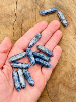 Blue Spot Jasper carved point gemstone, 33mm, from GemstoneGO featuring a terminated design and vibrant blue spots.
