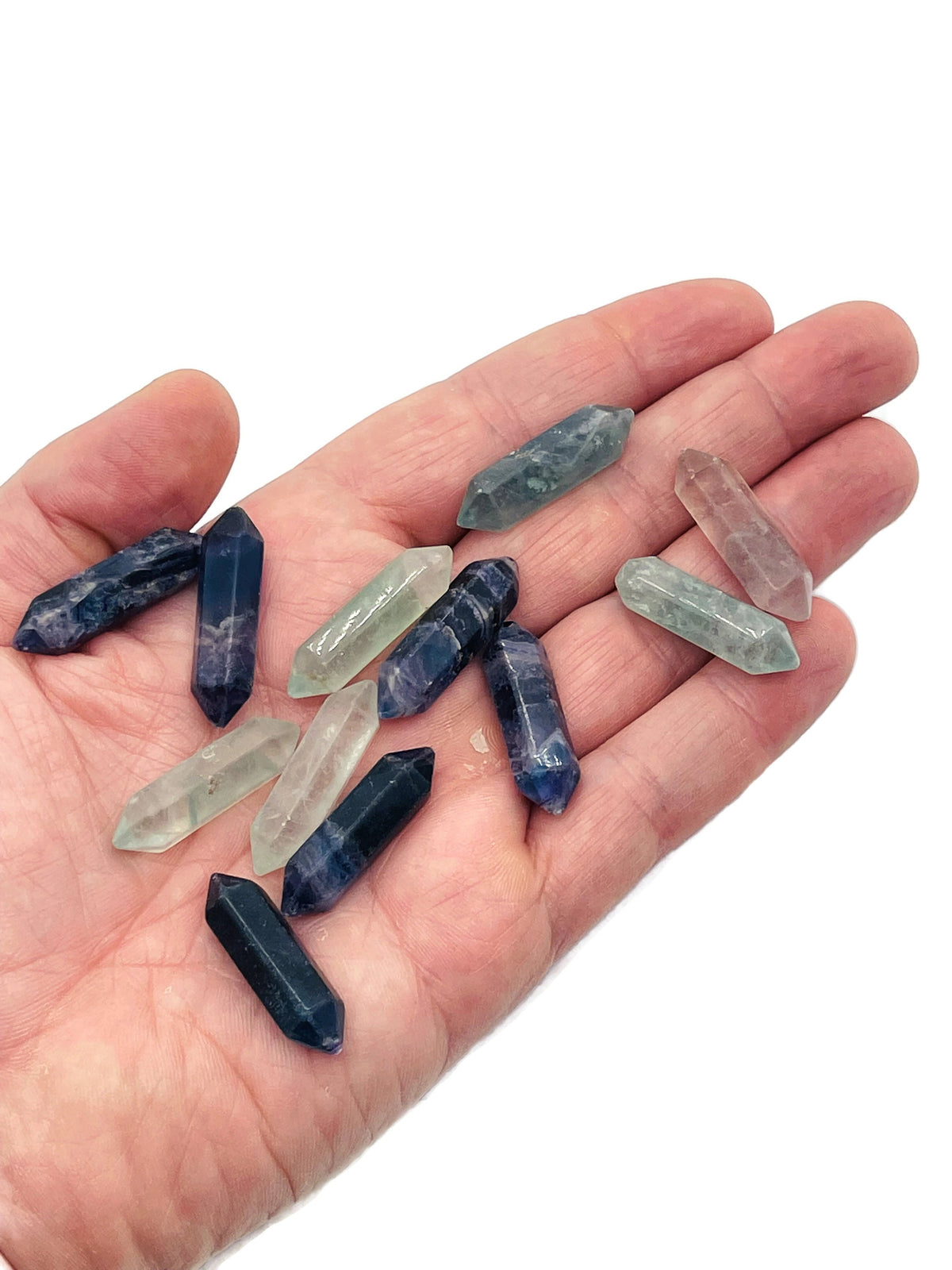 Polished fluorite terminated carved point, 33mm gemstone pendant from GemstoneGO with vibrant purple and green hues.