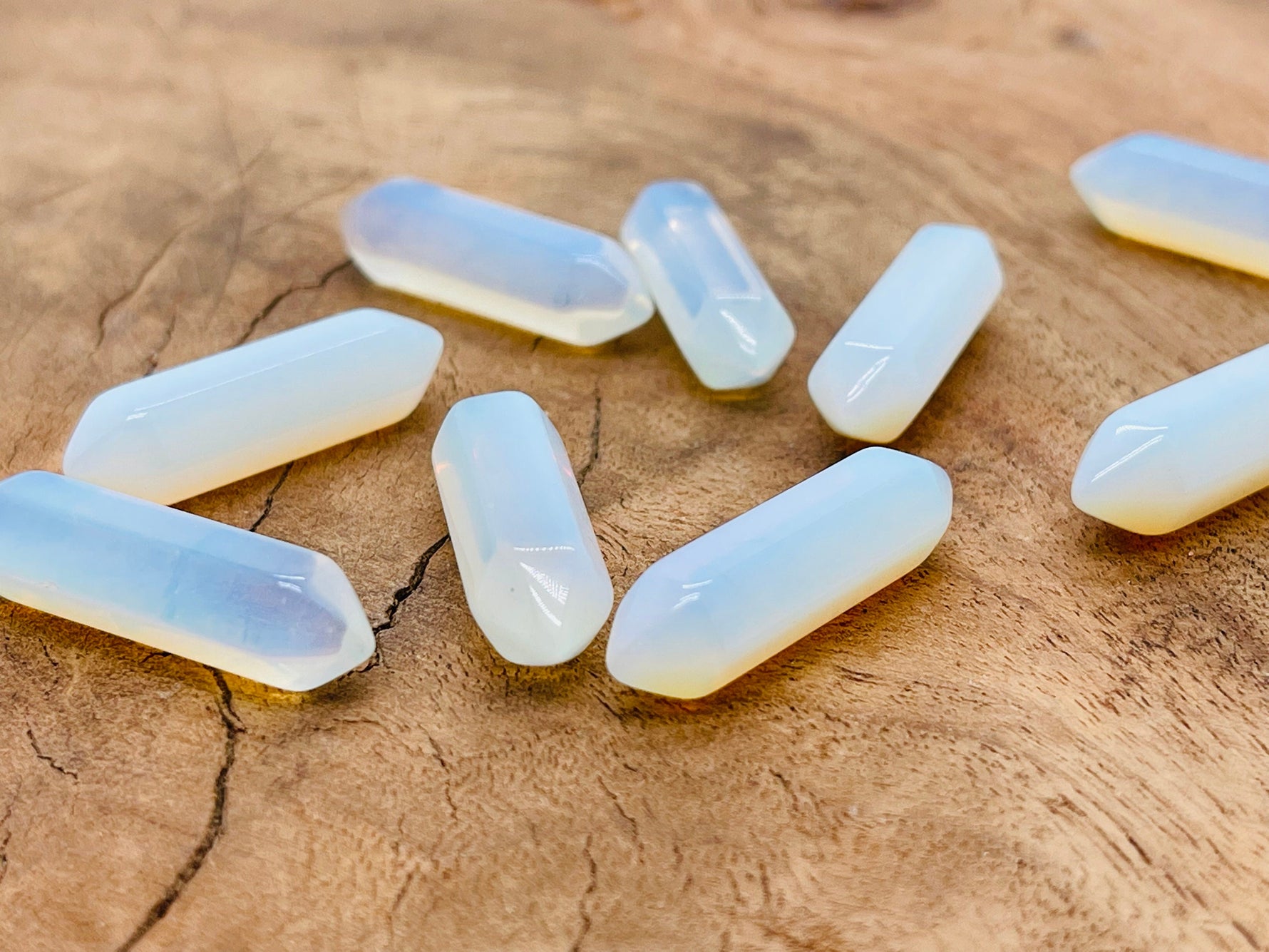 Opalite terminated carved point gemstone, 33mm, from GemstoneGO, showcasing smooth, polished surface with natural stone patterns.