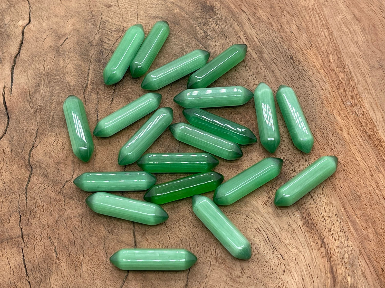 Green Cats Eye gemstone carved point, 33mm, with a polished termination, showcasing vibrant green color and eye-catching chatoyancy.
