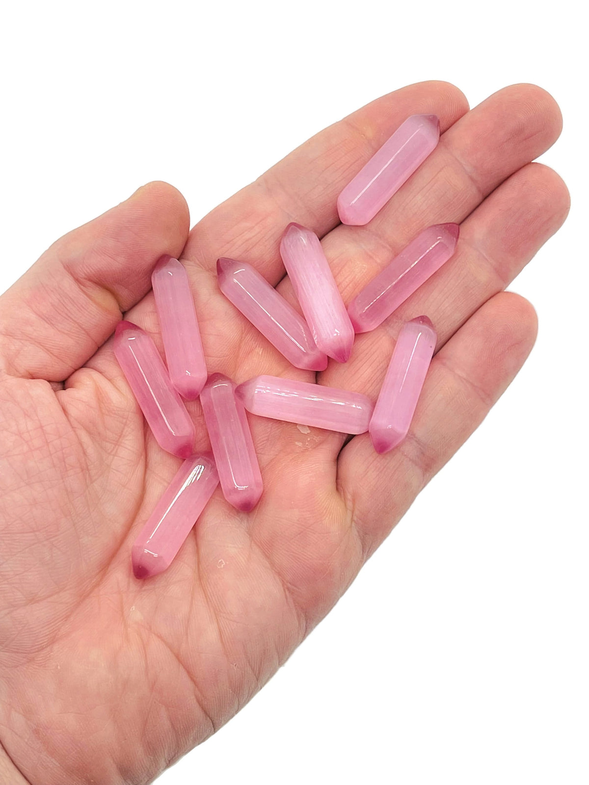 Pink Cats Eye carved point gemstone, 33mm, with a polished termination, from GemstoneGO, showcasing its vibrant pink color and smooth surface.