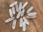 Clear quartz terminated carved point, 33mm gemstone from GemstoneGO, featuring a natural crystal shape and polished gemstone surface.