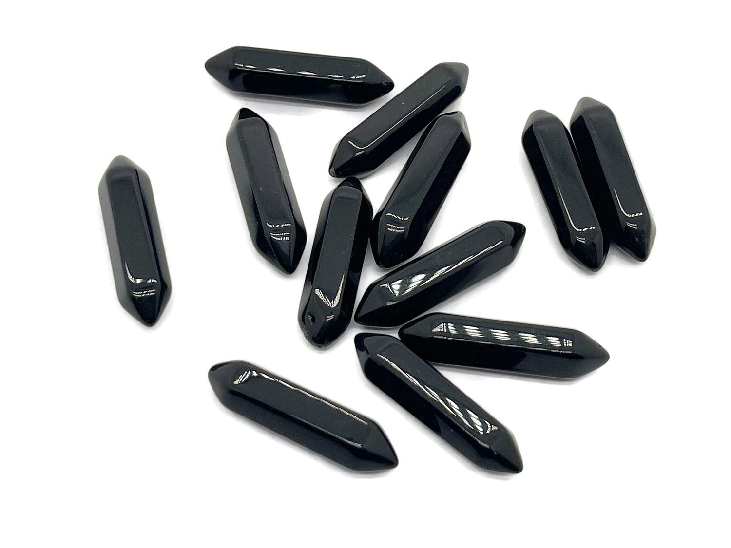 Obsidian terminated carved point gemstone from GemstoneGO, 33mm in length, showing polished black stone with carved details.