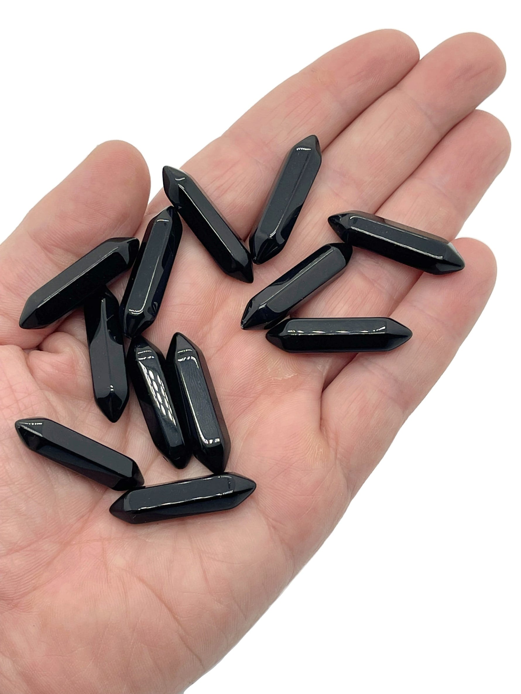 Obsidian terminated carved point crystal from GemstoneGO, 33mm length, showcasing smooth black stone with detailed carving.