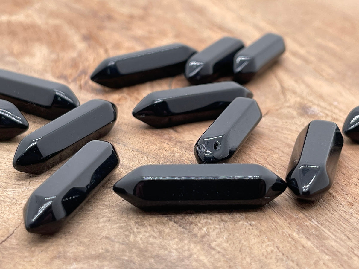 Obsidian terminated carved point gemstone from GemstoneGO, 33mm length, with polished and textured surface details.