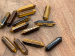 Tiger Eye terminated carved point gemstone, 33mm, from GemstoneGO, showing polished, natural stone with a pointed, carved tip.