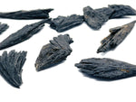 Raw black kyanite fan gemstone from GemstoneGO showcasing its natural, rough black stone with layered fan shape.